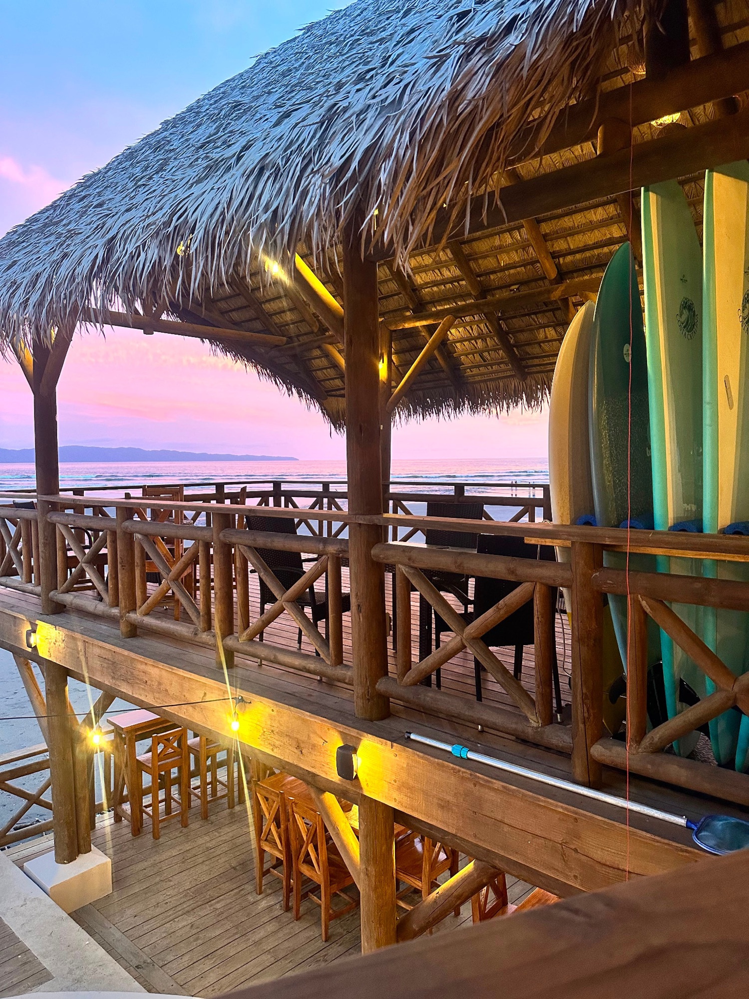 Surfboards ready beside the oceanfront deck